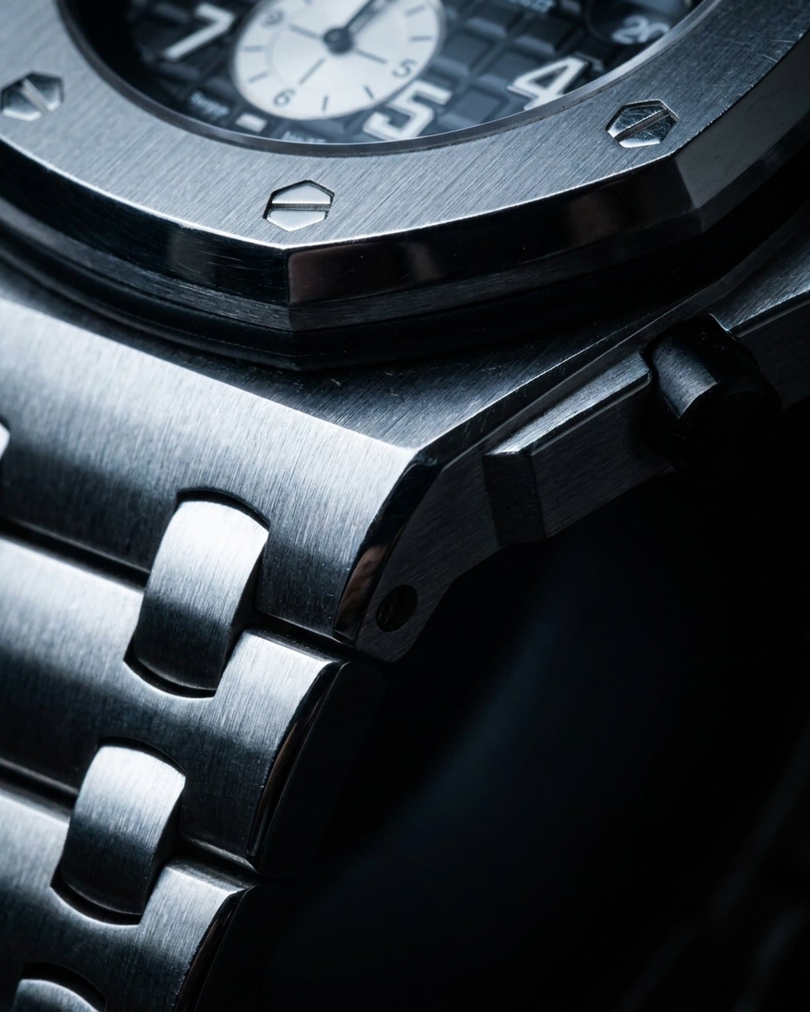 Close-up of the bezel screws and pushers on the octagon chronograph