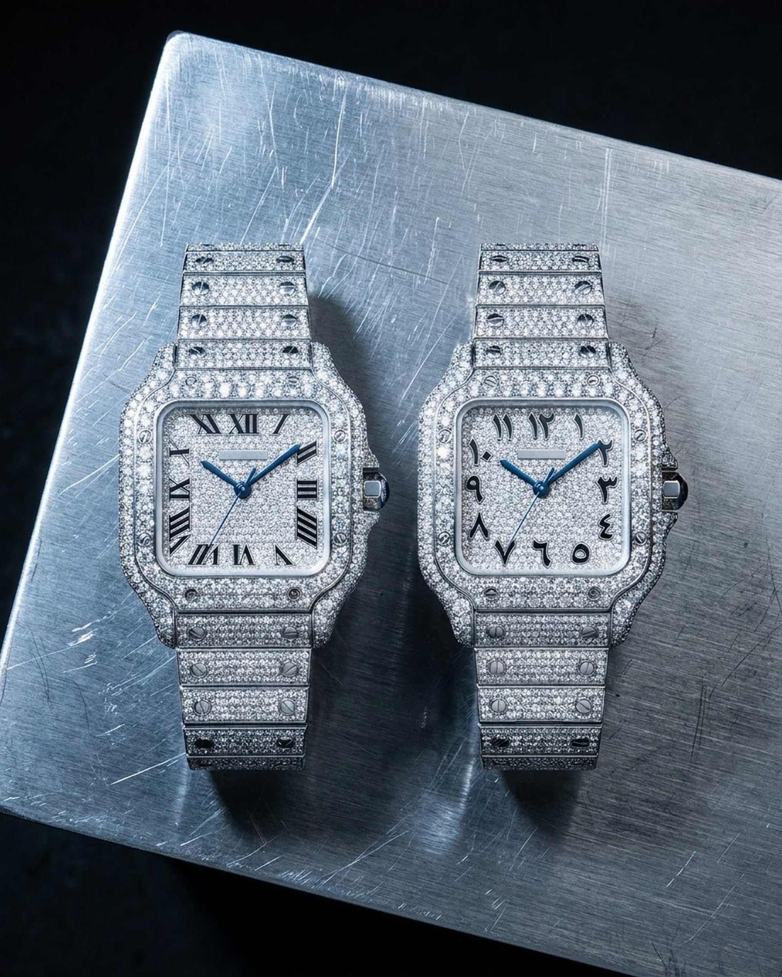 Two iced square watches with pave dials, Roman and Arabic-style numerals, side by side on scratched steel