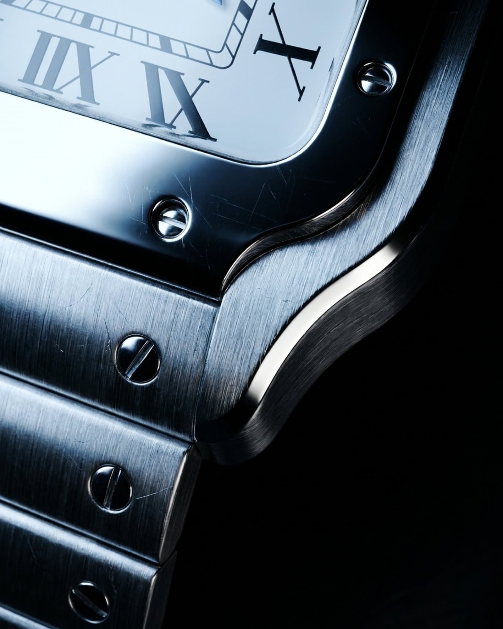 Close-up of the screwed bezel corner beside the white dial